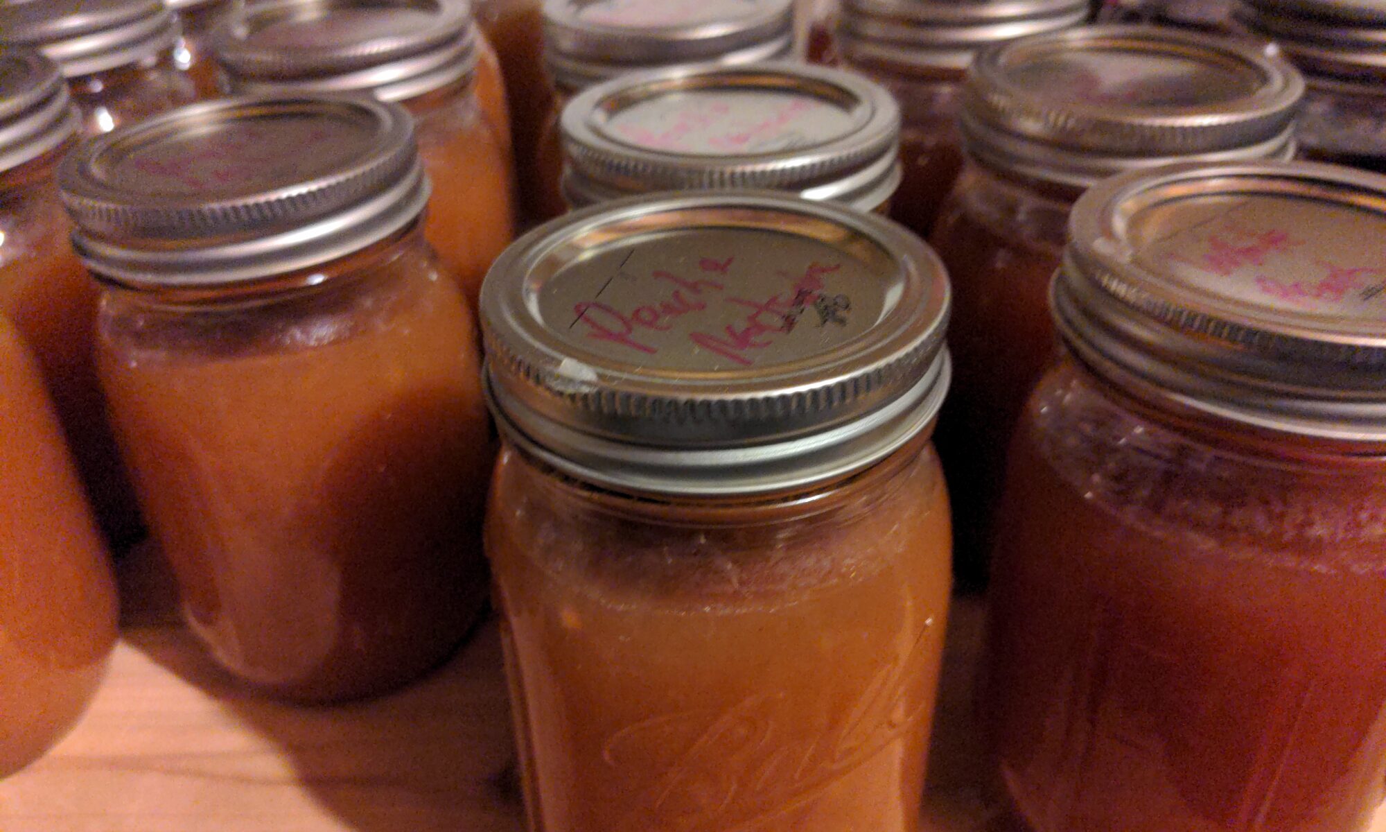 Multiple jars of peach jam.